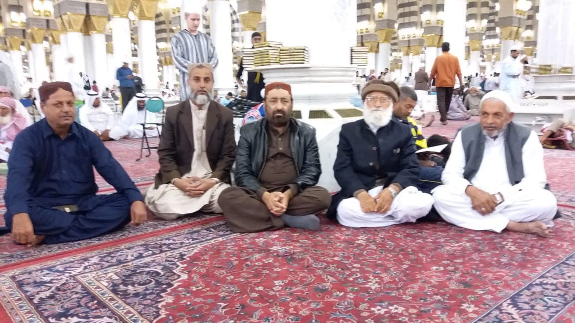 In a mosque courtyard with others.